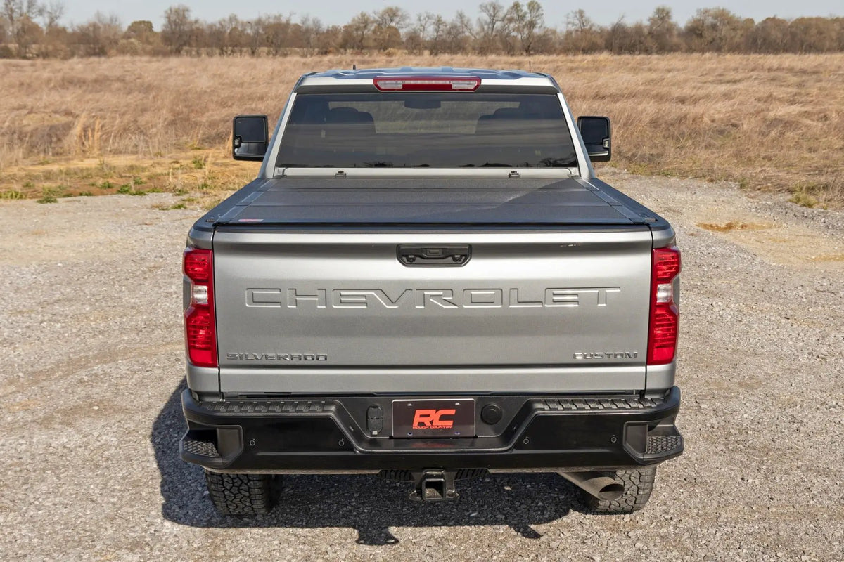 Hard Tri-Fold Flip Up Bed Cover | 6'9" Bed | Chevy/GMC Silverado/Sierra 2500HD/3500HD (20-26) by Rough Country